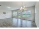 Spacious living room with lots of natural light, grey floors and a door leading to the outside at 523 Purple Finch Rd, Summerville, SC 29486