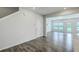 Spacious living room with hardwood floors, large windows, and an open layout flowing into the kitchen at 523 Purple Finch Rd, Summerville, SC 29486