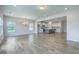 Open-concept floor plan connects the dining area and kitchen with grey floors and ample natural light at 523 Purple Finch Rd, Summerville, SC 29486