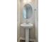 Charming powder room featuring a pedestal sink, round mirror, and tasteful decor for guests at 523 Purple Finch Rd, Summerville, SC 29486