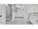 Modern bathroom with a glass-enclosed shower, white cabinetry, and sleek tile flooring at 5541 Alpine Dr, Summerville, SC 29483