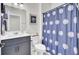 Bathroom featuring a vanity with navy cabinets, a white countertop and a blue patterned shower curtain at 5541 Alpine Dr, Summerville, SC 29483