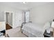 Cozy bedroom featuring a black metal bed frame, neutral carpet, white walls, and double door closet at 5541 Alpine Dr, Summerville, SC 29483