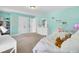 Bright bedroom with teal walls, carpeted floors, double closet, and a dresser with decorative mirror at 5541 Alpine Dr, Summerville, SC 29483