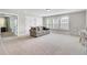 Bonus room featuring carpeted floors, three windows, and a sofa, creating a bright and cozy space at 5541 Alpine Dr, Summerville, SC 29483