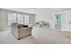 Bonus room featuring carpeted floors, three windows, and a sofa creating a bright and versatile area at 5541 Alpine Dr, Summerville, SC 29483