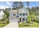 Charming two-story home featuring a welcoming front porch, well-manicured lawn, and attached two-car garage at 5541 Alpine Dr, Summerville, SC 29483