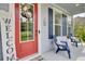 Charming front porch with comfortable blue chairs, a welcoming wreath, and stylish decor elements at 5541 Alpine Dr, Summerville, SC 29483