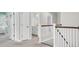 Hallway with white doors, white wood trim, neutral carpet and a view into a nearby bathroom at 5541 Alpine Dr, Summerville, SC 29483