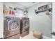Modern laundry room with silver washer/dryer, shelves, and shiplap accent wall for a clean and efficient space at 5541 Alpine Dr, Summerville, SC 29483