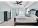 A soothing main bedroom featuring a tray ceiling, ceiling fan, and a cozy window nook for relaxation at 5541 Alpine Dr, Summerville, SC 29483
