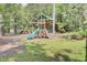 Fun wooden playset featuring a slide, swing, and climbing wall, perfect for backyard play at 5541 Alpine Dr, Summerville, SC 29483