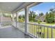 Spacious covered front porch with white railings and columns offering a view of the front yard and neighborhood at 5541 Alpine Dr, Summerville, SC 29483