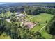 An aerial view reveals a community pool, playground, tennis and sand volleyball courts, and sprawling green fields at 596 Wayton Cir, Moncks Corner, SC 29461