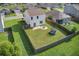 A captivating aerial view of a fenced backyard, complete with lush green grass and a trampoline for outdoor fun at 596 Wayton Cir, Moncks Corner, SC 29461