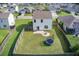 Aerial view of a fenced backyard, firepit, and community pond nearby at 596 Wayton Cir, Moncks Corner, SC 29461