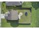 Aerial view of a well-maintained backyard with green lawn, fire pit area, a trampoline and full perimeter fence at 596 Wayton Cir, Moncks Corner, SC 29461