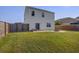 A large backyard featuring a wood fence, a paved patio, and lush green grass at 596 Wayton Cir, Moncks Corner, SC 29461