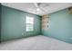 This empty bedroom includes a ceiling fan, window, gray carpet, and green walls at 596 Wayton Cir, Moncks Corner, SC 29461