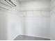 This walk-in closet includes racks for storage, with carpeting and base molding at 596 Wayton Cir, Moncks Corner, SC 29461