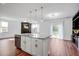 Open-concept kitchen with island, granite countertops, stainless steel appliances, and hardwood flooring at 596 Wayton Cir, Moncks Corner, SC 29461