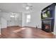 The living room has wood floors, a fireplace with a TV above it, a ceiling fan, and plenty of natural light at 596 Wayton Cir, Moncks Corner, SC 29461