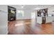 Open-concept living room boasts a fireplace, hardwood floors, and seamless flow to the kitchen with its modern finishes at 596 Wayton Cir, Moncks Corner, SC 29461