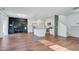 Bright, open-concept kitchen and living area with modern appliances, a breakfast bar, and elegant wood flooring at 596 Wayton Cir, Moncks Corner, SC 29461