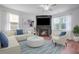 Elegant living room with a cozy fireplace, modern furnishings, and abundant natural light at 596 Wayton Cir, Moncks Corner, SC 29461