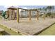 Community playground with a jungle gym, swings, and a wood chip ground cover for safety and fun at 596 Wayton Cir, Moncks Corner, SC 29461