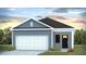 Charming single-story home featuring a two-car garage, black door, and attractive landscaping at 6218 Gritman Dr, Hollywood, SC 29470
