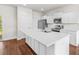 Bright kitchen features white cabinets, stainless steel appliances, and a large center island at 7787 Montview Rd, North Charleston, SC 29418