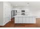 Bright kitchen features white cabinets, stainless steel appliances, and a large center island at 7787 Montview Rd, North Charleston, SC 29418