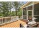 Relaxing back deck with wicker chairs and a view of the surrounding trees at 800 Enclave Ter, Summerville, SC 29483