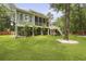 Expansive backyard featuring a well-manicured lawn, mature trees, and outdoor seating areas for relaxation at 800 Enclave Ter, Summerville, SC 29483