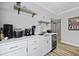 Wet bar featuring white marble countertops, modern appliances, floating shelves, and a beverage cooler at 800 Enclave Ter, Summerville, SC 29483