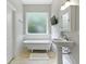 Charming bathroom with a classic clawfoot tub, pedestal sink, and tiled floors at 800 Enclave Ter, Summerville, SC 29483