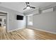 Bedroom with wood-look flooring, ceiling fan, television, and window at 800 Enclave Ter, Summerville, SC 29483