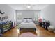 Well-lit bedroom featuring hardwood floors, ceiling fan, two windows, and neutral decor at 800 Enclave Ter, Summerville, SC 29483