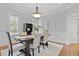 Dining room featuring wainscoting walls, a chandelier, and seating for six at 800 Enclave Ter, Summerville, SC 29483