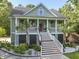 Charming elevated home with a welcoming front porch, elegant columns, and beautiful landscaping at 800 Enclave Ter, Summerville, SC 29483