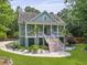 Charming two-story home featuring a wide front porch, decorative columns, and beautiful landscaping at 800 Enclave Ter, Summerville, SC 29483