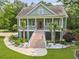 Charming two-story home featuring a wide front porch, decorative columns, and beautiful landscaping at 800 Enclave Ter, Summerville, SC 29483