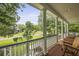 Inviting front porch with wood chairs, wooden floors, and scenic neighborhood views at 800 Enclave Ter, Summerville, SC 29483