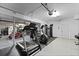 Home gym setup in garage, equipped with treadmill, elliptical, and weight machine at 800 Enclave Ter, Summerville, SC 29483