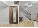 Hallway featuring a staircase, wooden accents and flooring with a glass-front sauna at 800 Enclave Ter, Summerville, SC 29483