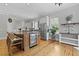 Gourmet kitchen with stainless steel appliances, large island with beverage fridge, and custom cabinetry at 800 Enclave Ter, Summerville, SC 29483