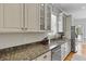 Stylish kitchen featuring granite countertops, glass-front cabinets, and stainless steel appliances at 800 Enclave Ter, Summerville, SC 29483