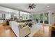 Open-concept living room features a large sectional couch, hardwood floors, and ample natural light at 800 Enclave Ter, Summerville, SC 29483