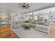 Spacious living room with hardwood floors, large sectional couch, and views into the kitchen at 800 Enclave Ter, Summerville, SC 29483